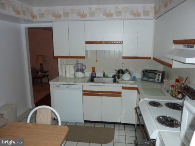 2903 Fallstaff Road, Unit 503 Baltimore, MD 21209 - Photo 10 of 20 a kitchen with a sink a stove and cabinets