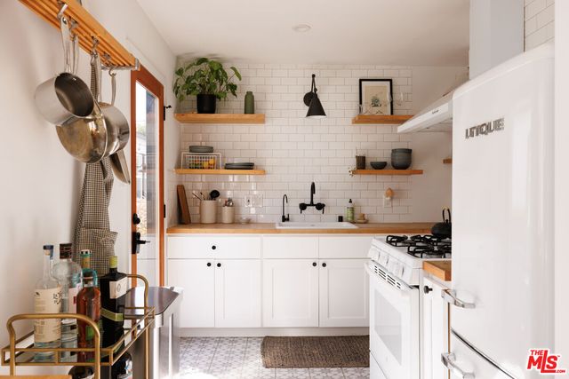 a bathroom with a sink a mirror and shower