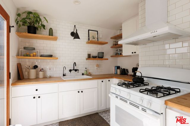a kitchen with cabinets and white stainless steel appliances
