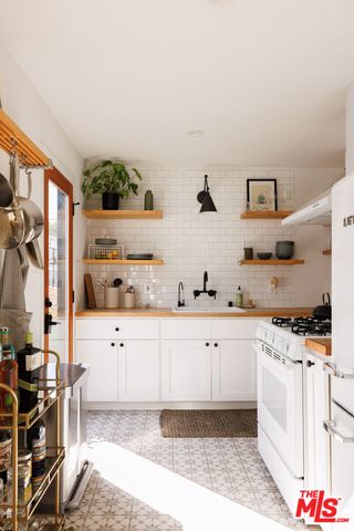 a kitchen with stainless steel appliances a sink and a stove