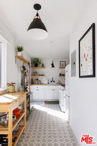 a kitchen with a sink a stove and cabinets