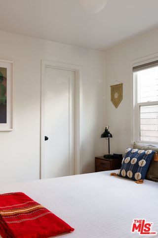 a bedroom with a bed and a lamp