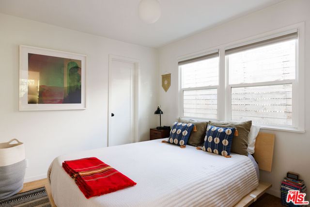 a bedroom with a bed and window