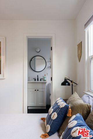 a bedroom with a bed and window