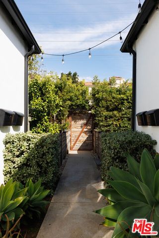 a backyard of a house with a yard and outdoor seating