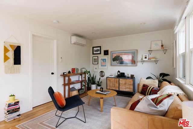 a living room with furniture and painting on the wall
