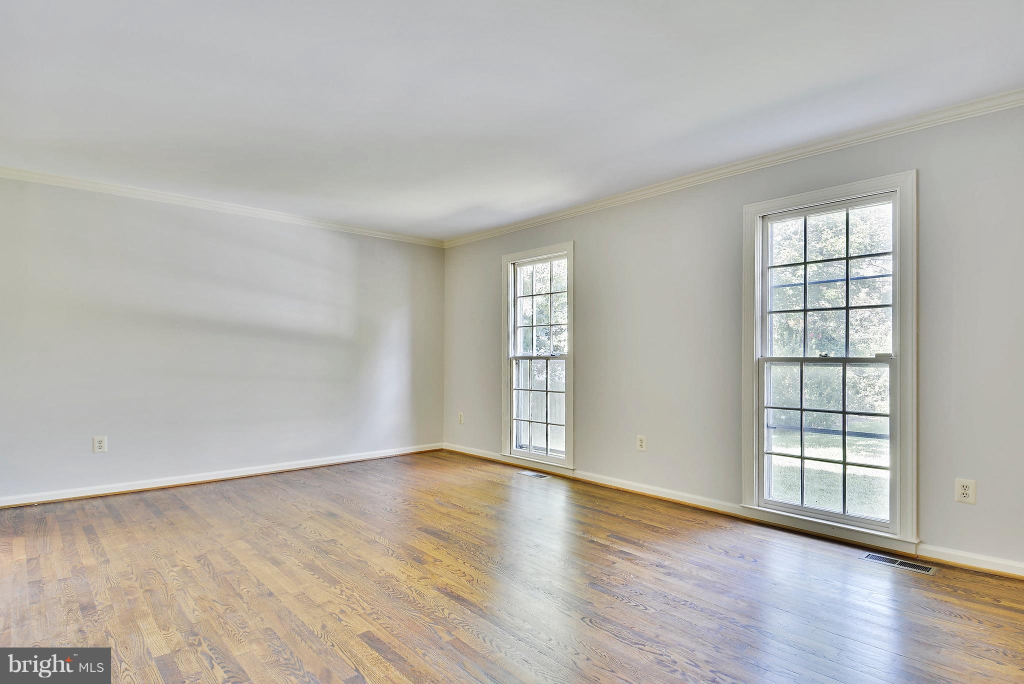 1026 Riva Ridge Drive Great Falls, VA 22066 - Photo 6 of 30 an empty room with wooden floor and windows