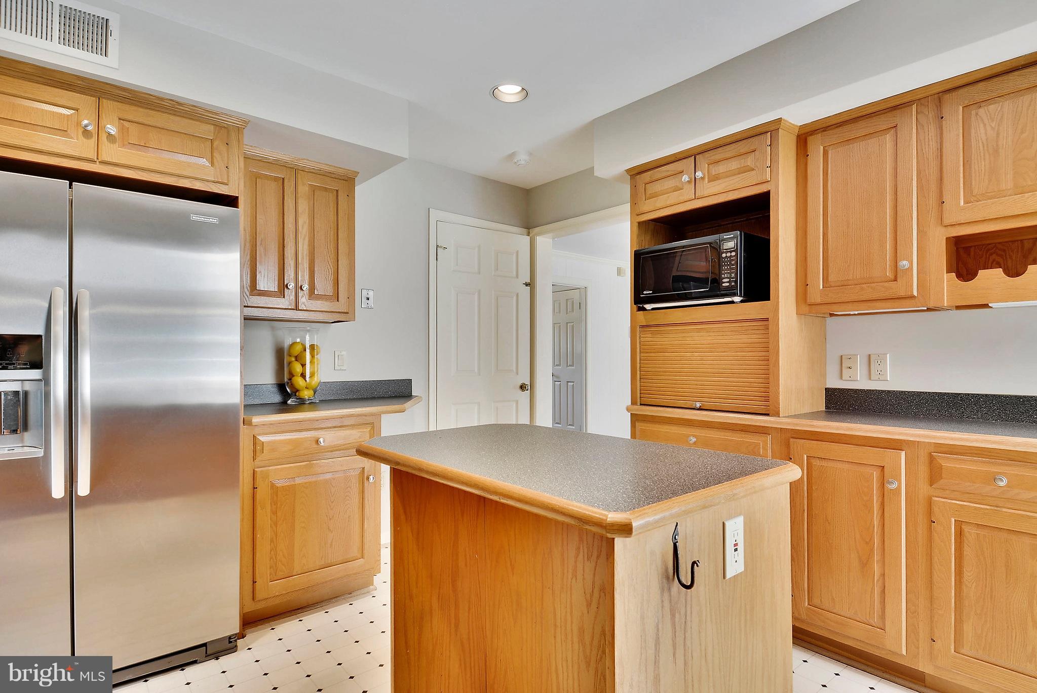 1026 Riva Ridge Drive Great Falls, VA 22066 - Photo 10 of 30 a kitchen with stainless steel appliances granite countertop a refrigerator and a stove top oven