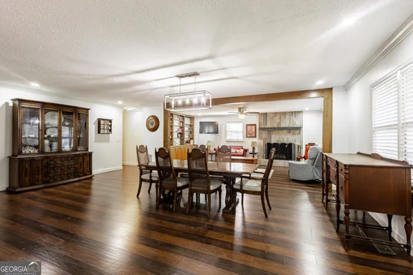 a view of a dining room with furniture and wooden floor