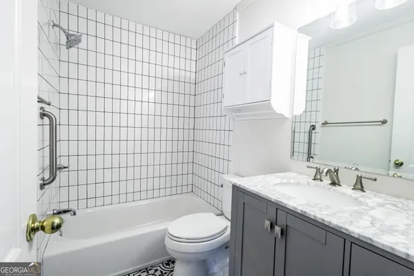 a bedroom with a bed and a mirror