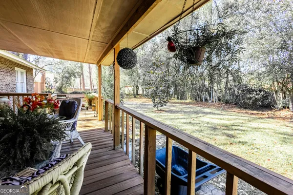 a view of a yard with wooden fence