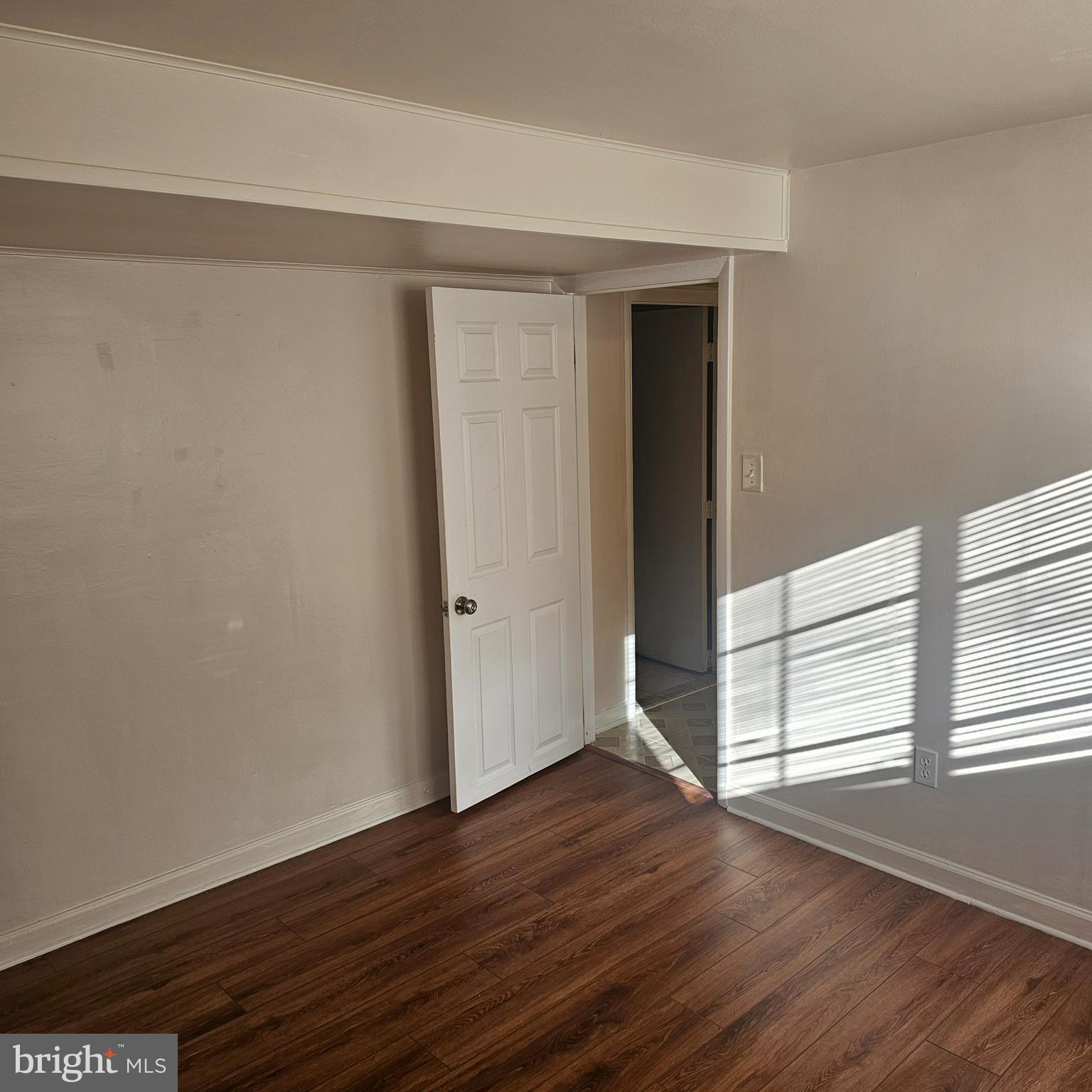 616 Hollywood Avenue Silver Spring, MD 20904 - Photo 2 of 9 a view of an empty room with wooden floor and a window