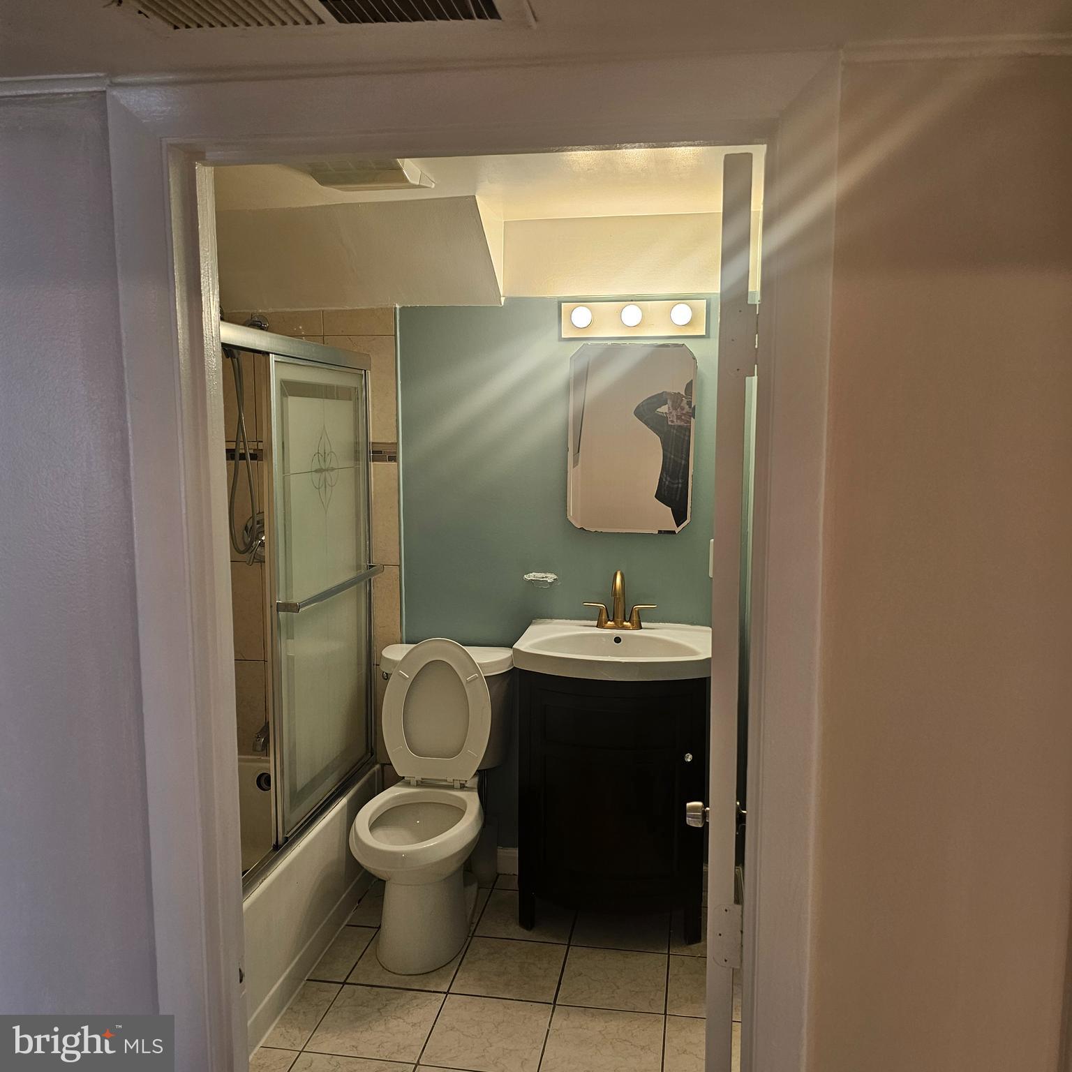 616 Hollywood Avenue Silver Spring, MD 20904 - Photo 4 of 9 a bathroom with a toilet a sink and mirror