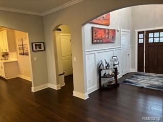 2500 Walnut View Drive Howell, MI 48855 - Photo 3 of 41 Foyer entrance featuring arched walkways, crown molding, and dark wood finished floors