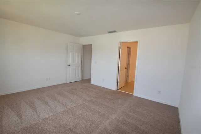 a bathroom with a shower and a glass door