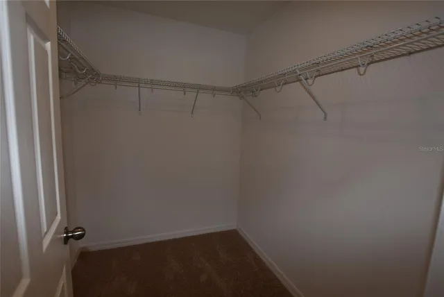 a white toilet sitting next to a shower