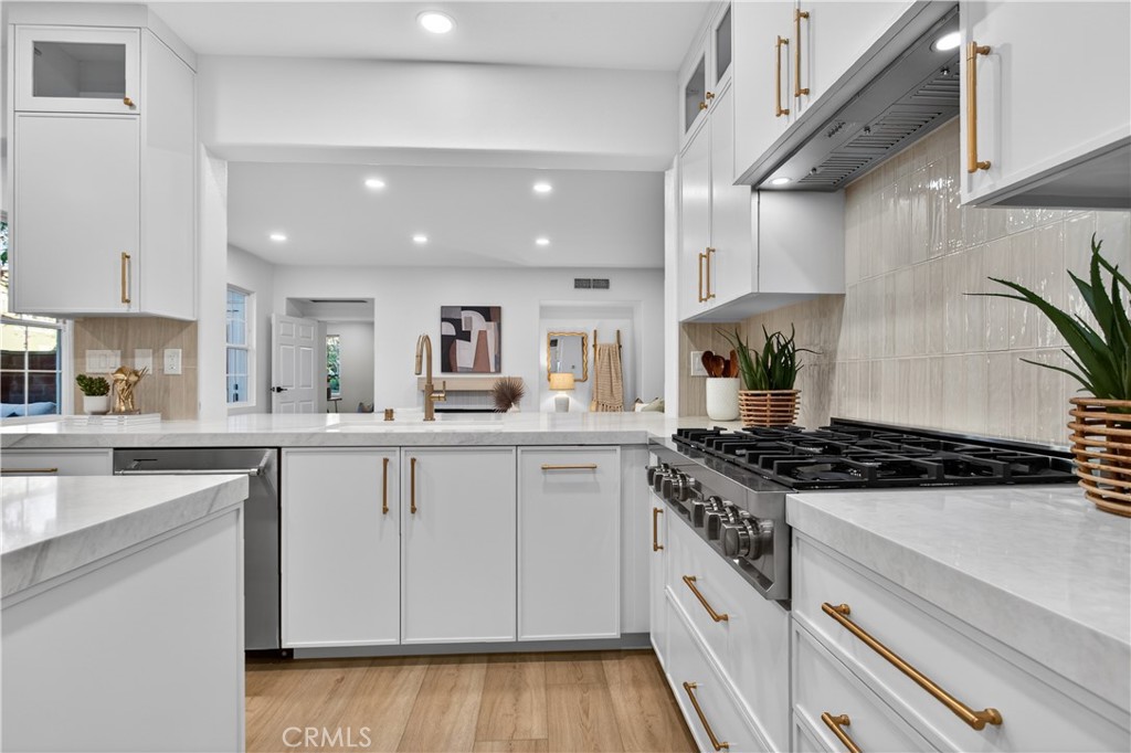 81 Zinnia Street Ladera Ranch, CA 92694 - Photo 11 of 47 a kitchen with a white cabinets and stove