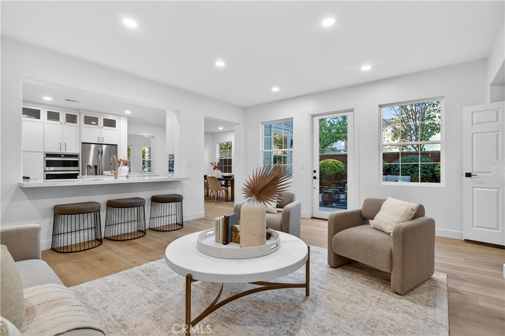 81 Zinnia Street Ladera Ranch, CA 92694 - Photo 12 of 47 a living room with furniture a fireplace and a table