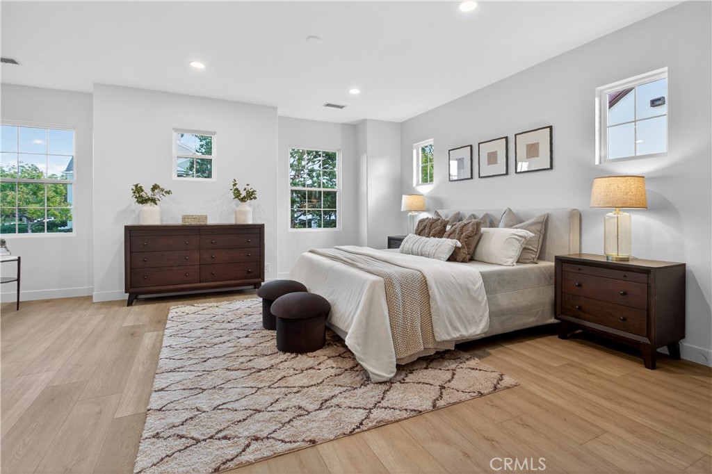81 Zinnia Street Ladera Ranch, CA 92694 - Photo 18 of 47 a bedroom with a bed and wooden floor