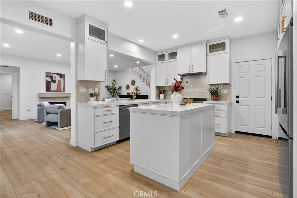 81 Zinnia Street Ladera Ranch, CA 92694 - Photo 2 of 47 a kitchen with white cabinets and white appliances