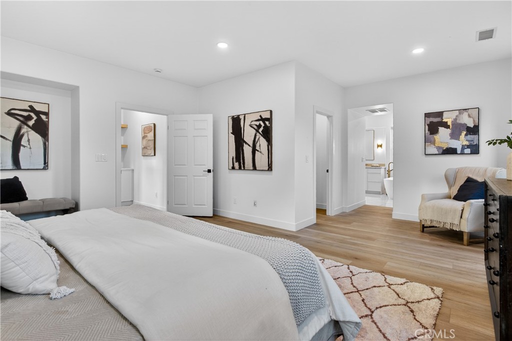 81 Zinnia Street Ladera Ranch, CA 92694 - Photo 21 of 47 a bedroom with a large bed and a couch