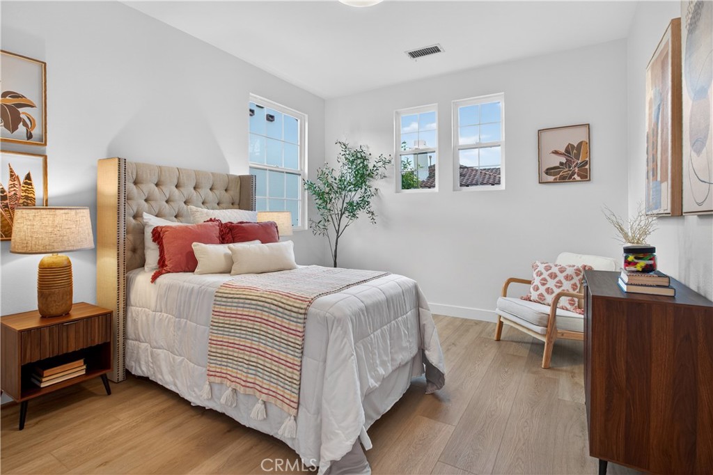 81 Zinnia Street Ladera Ranch, CA 92694 - Photo 26 of 47 a bedroom with bed and wooden floor