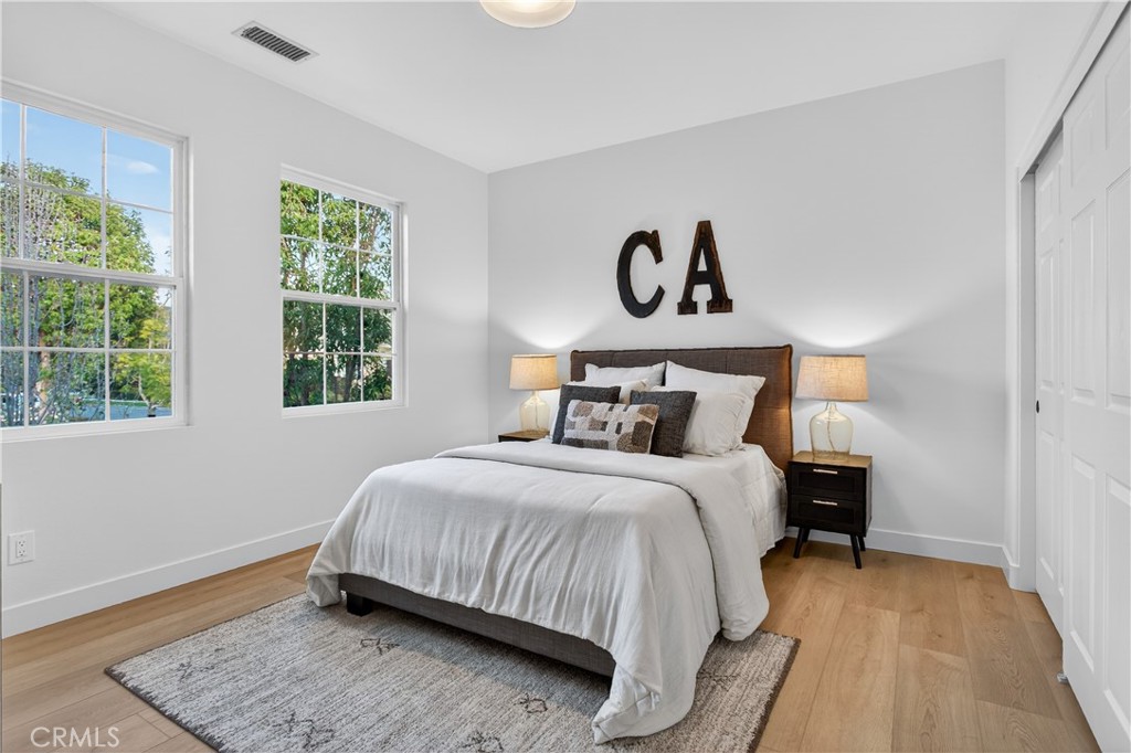 81 Zinnia Street Ladera Ranch, CA 92694 - Photo 28 of 47 a bedroom with a bed and wooden floor