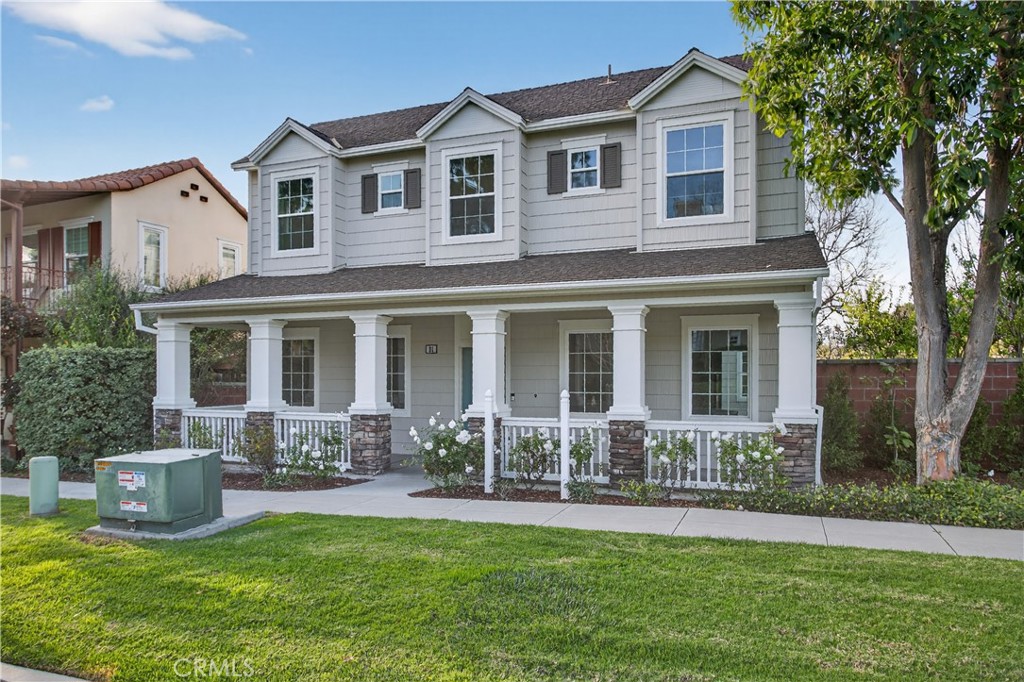 81 Zinnia Street Ladera Ranch, CA 92694 - Photo 33 of 47 a front view of a house with a yard and potted plants