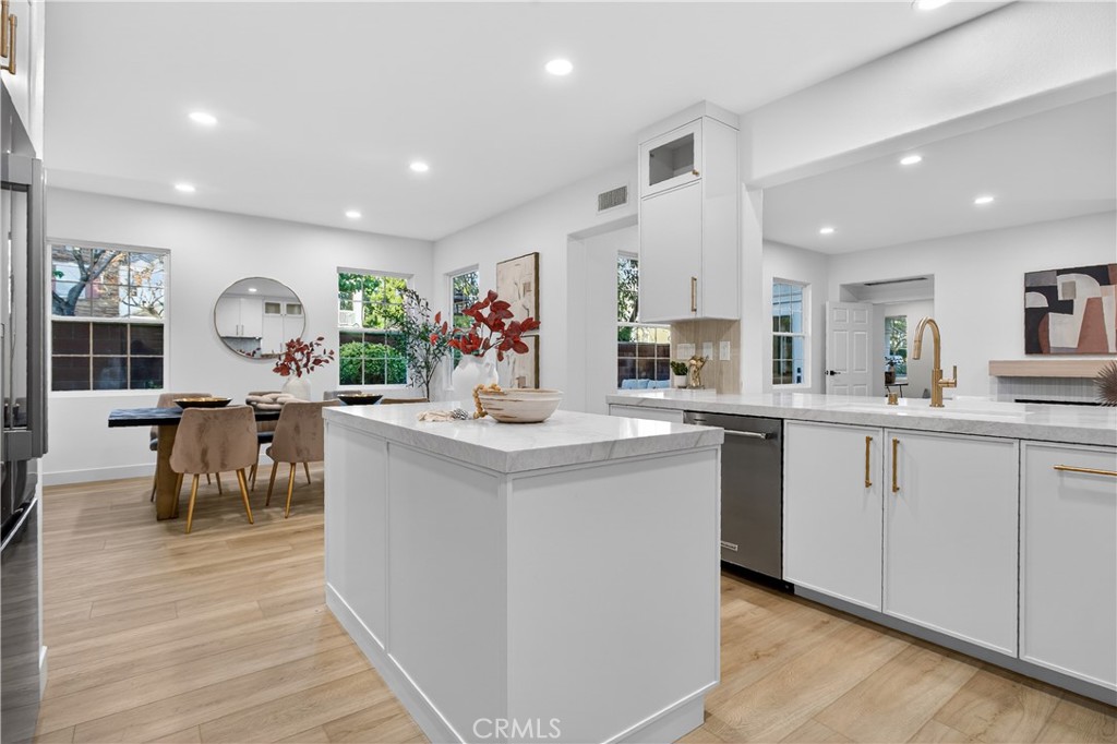 81 Zinnia Street Ladera Ranch, CA 92694 - Photo 10 of 47 a kitchen with lots of counter top space and painting on the wall