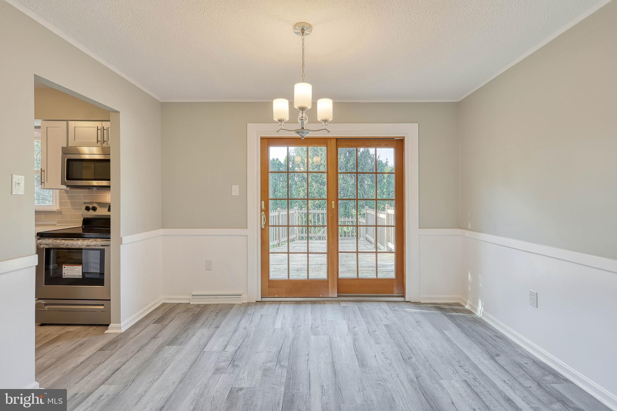 2285 Esbenshade Road York, PA 17408 - Photo 18 of 41 an empty room with wooden floor cabinet and windows