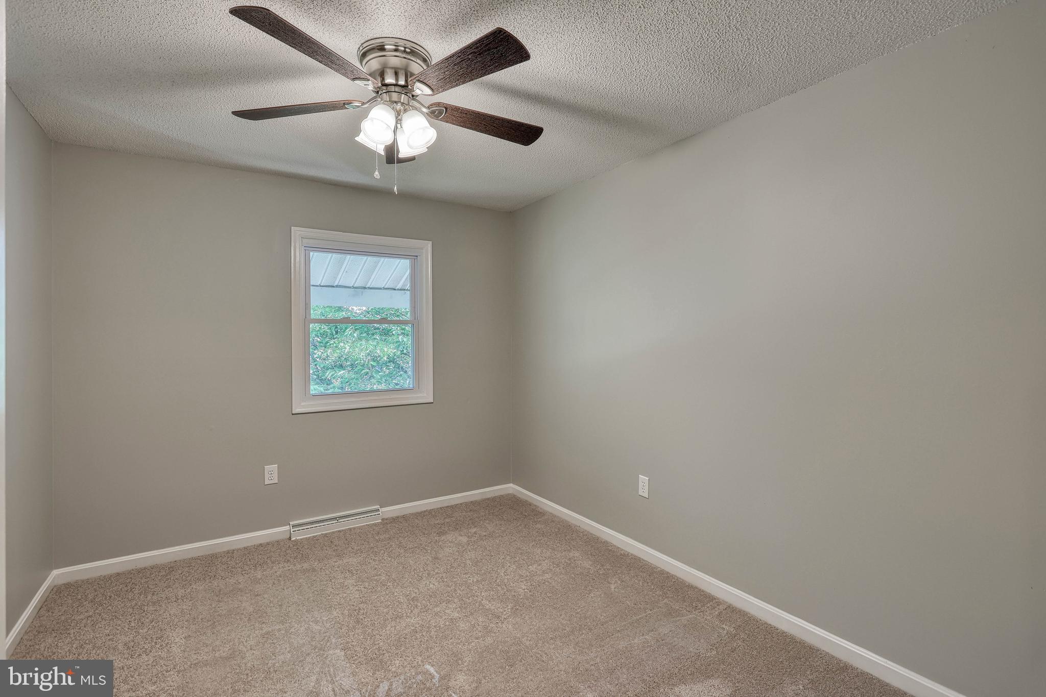 2285 Esbenshade Road York, PA 17408 - Photo 26 of 41 an empty room with a window and a fan