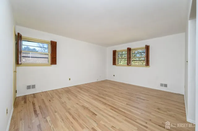 a view of an empty room and wooden floor