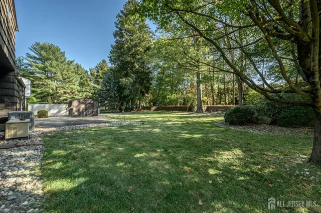a view of a house with a backyard and tree