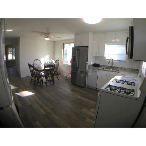 a kitchen with a table and chairs