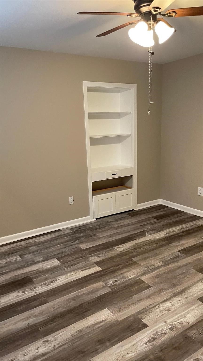 2107 Timber Lane Conroe, TX 77301 - Photo 11 of 12 a view of a livingroom with an empty space & a ceiling fan