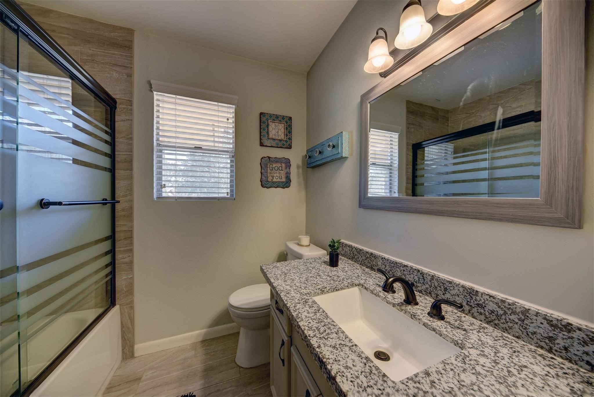 2107 Timber Lane Conroe, TX 77301 - Photo 10 of 12 a bathroom with a sink vanity granite and toilet