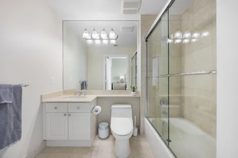 a bathroom with a toilet a sink and shower