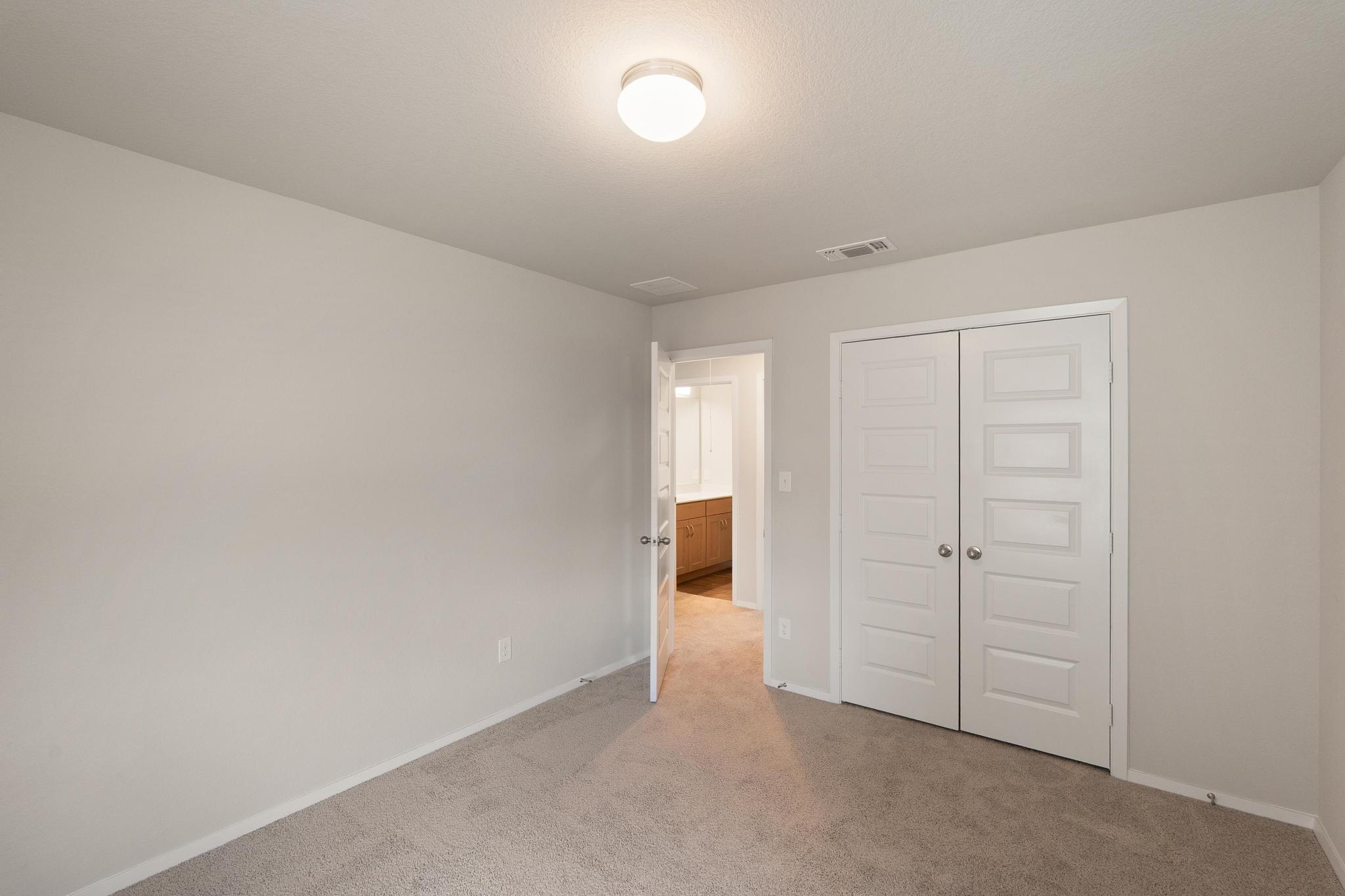 2812 Steels Road Manor, TX 78653 - Photo 22 of 25 Plush carpeting and neutral tones define this versatile bedroom with double closet doors.