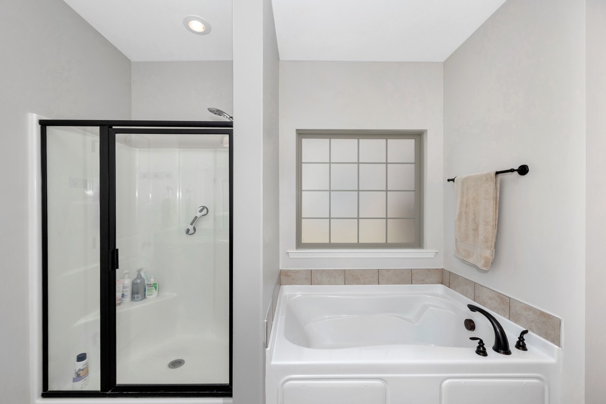 14469 Turnberry Lane Athens, AL 35613 - Photo 17 of 33 a bathroom with a bathtub and a shower