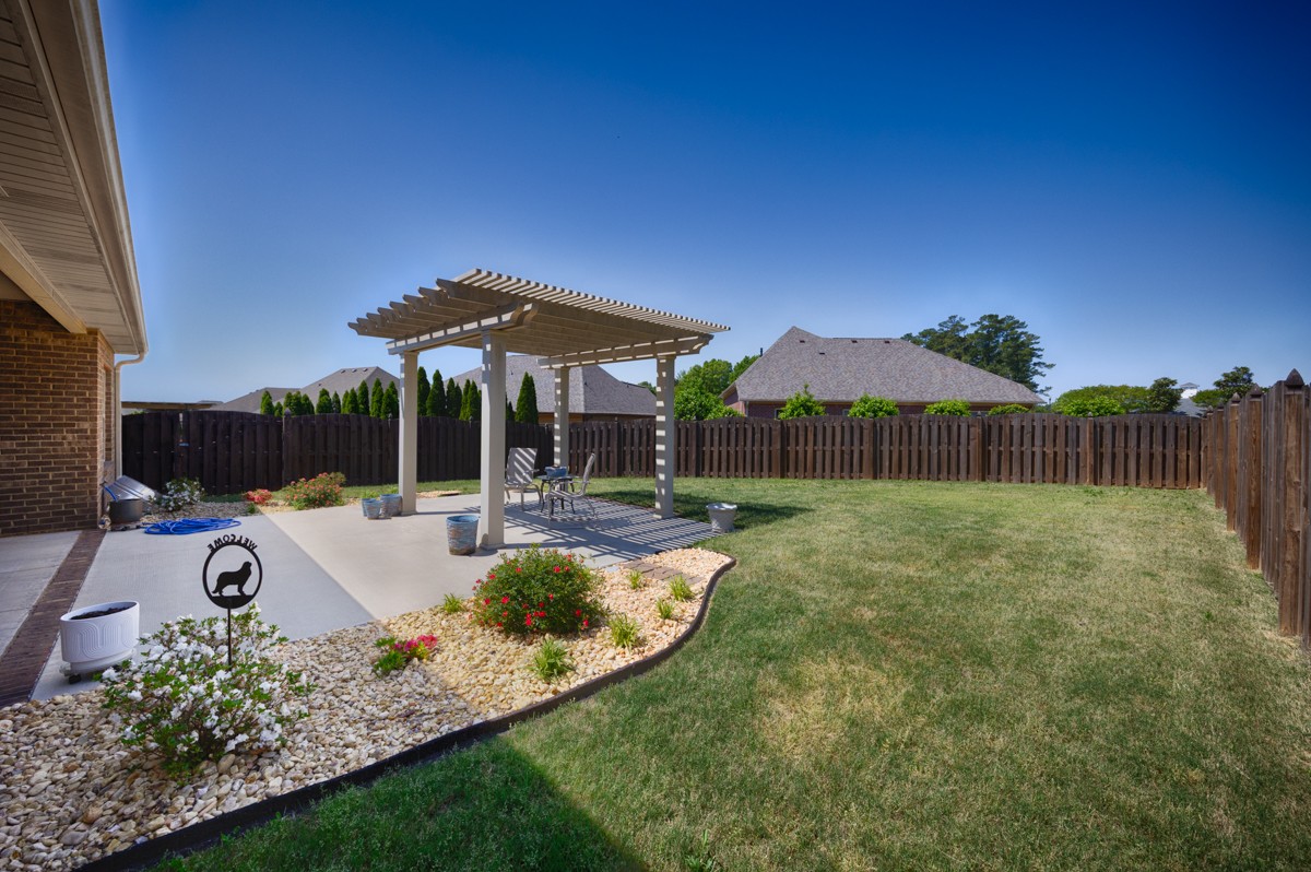 14469 Turnberry Lane Athens, AL 35613 - Photo 28 of 33 a view of a backyard with couches plants and large tree