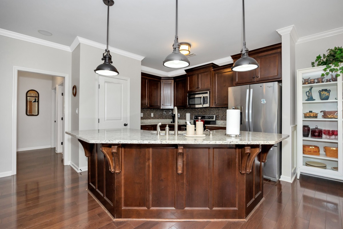 14469 Turnberry Lane Athens, AL 35613 - Photo 3 of 33 a kitchen with stainless steel appliances granite countertop a sink a stove and a wooden floors