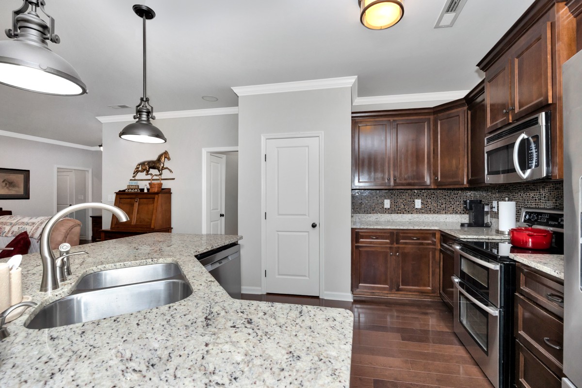 14469 Turnberry Lane Athens, AL 35613 - Photo 4 of 33 a kitchen with stainless steel appliances granite countertop a sink stove and refrigerator