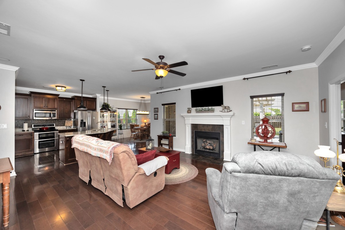 14469 Turnberry Lane Athens, AL 35613 - Photo 8 of 33 a living room with furniture a fireplace and a flat screen tv