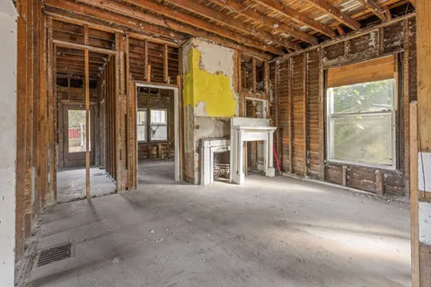 a view of a porch with a table and chairs