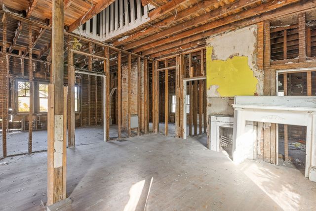 a view of a porch with a door and a fireplace