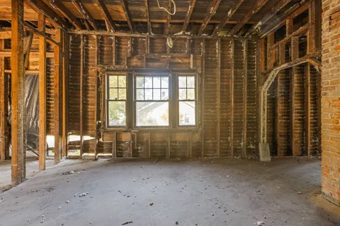 a view of an empty room with a fireplace