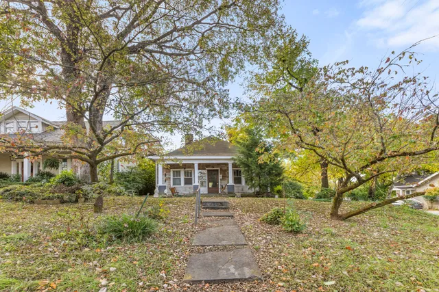 a front view of a house with a garden