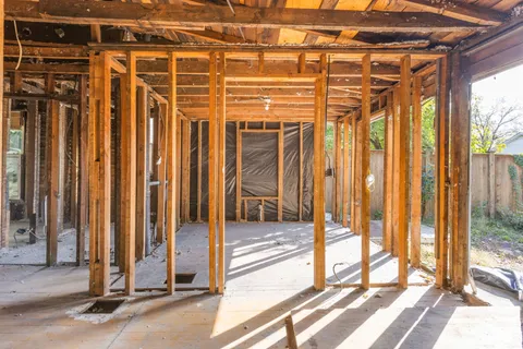 a view of a room with wooden walls and floor to ceiling windows