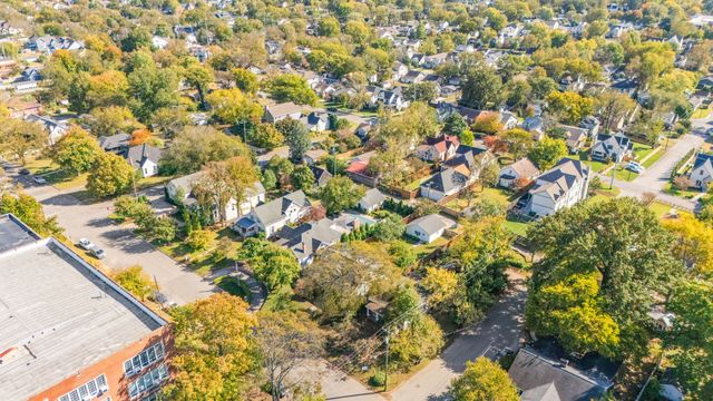 an aerial view of a residential houses with city view