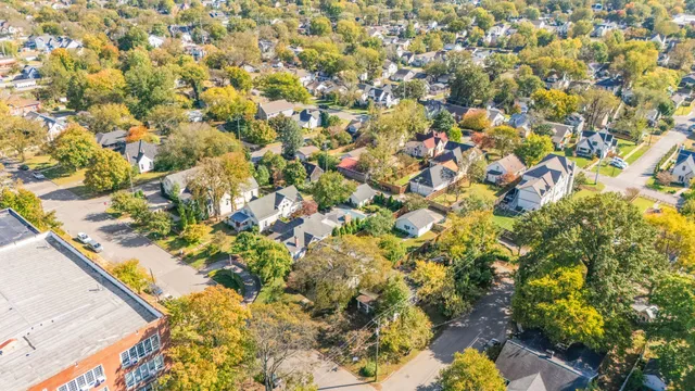 an aerial view of a residential houses with city view